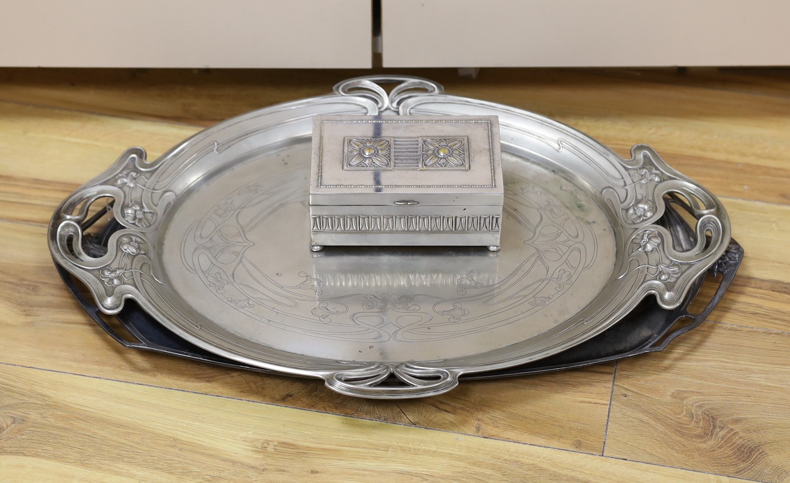 An Edwardian oval Art Nouveau metal tray, a similar oak and pewter tray and a WMF box, pewter tray 58 cms wide.